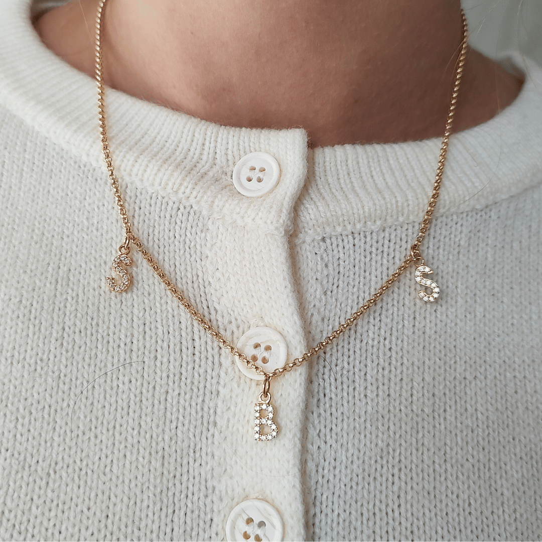Die MIA Kette mit drei funkelnden Buchstaben-Anhängern in Gold – eine Familienkette, die Mama ihre Kinder nah am Herzen tragen lässt. – diese personalisierte Familienkette aus echtem Gold oder 925 Sterlingsilber ist mehr als Schmuck: Sie ist ein Versprechen.